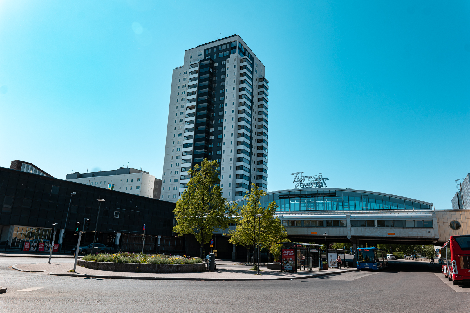 A building with trees and a bus stop</p>
<p>Description automatically generated with medium confidence