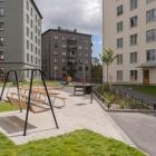 Bildtext: Lägenhetshus med en innergård framför. På gården står en hänggunga.
Svenska Bostäders Stockholmshus i Ledinge, Tensta. Foto: Svenska Bostäder/Peter Lydén