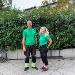Fastighetsvärdarna Niclas Palm och Maria Arvidsson visar Botkyrkabyggens nya profilkläder. Foto: Botkyrkabyggen